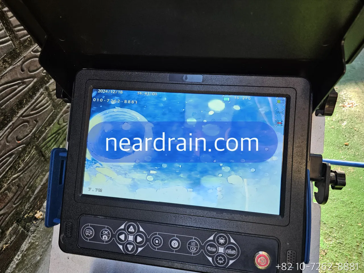 Camera monitor showing the inside of a drain pipe after cleaning