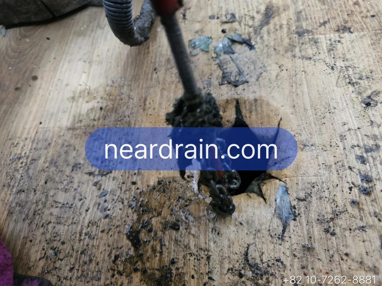 Spring cable clearing a bathroom floor drain