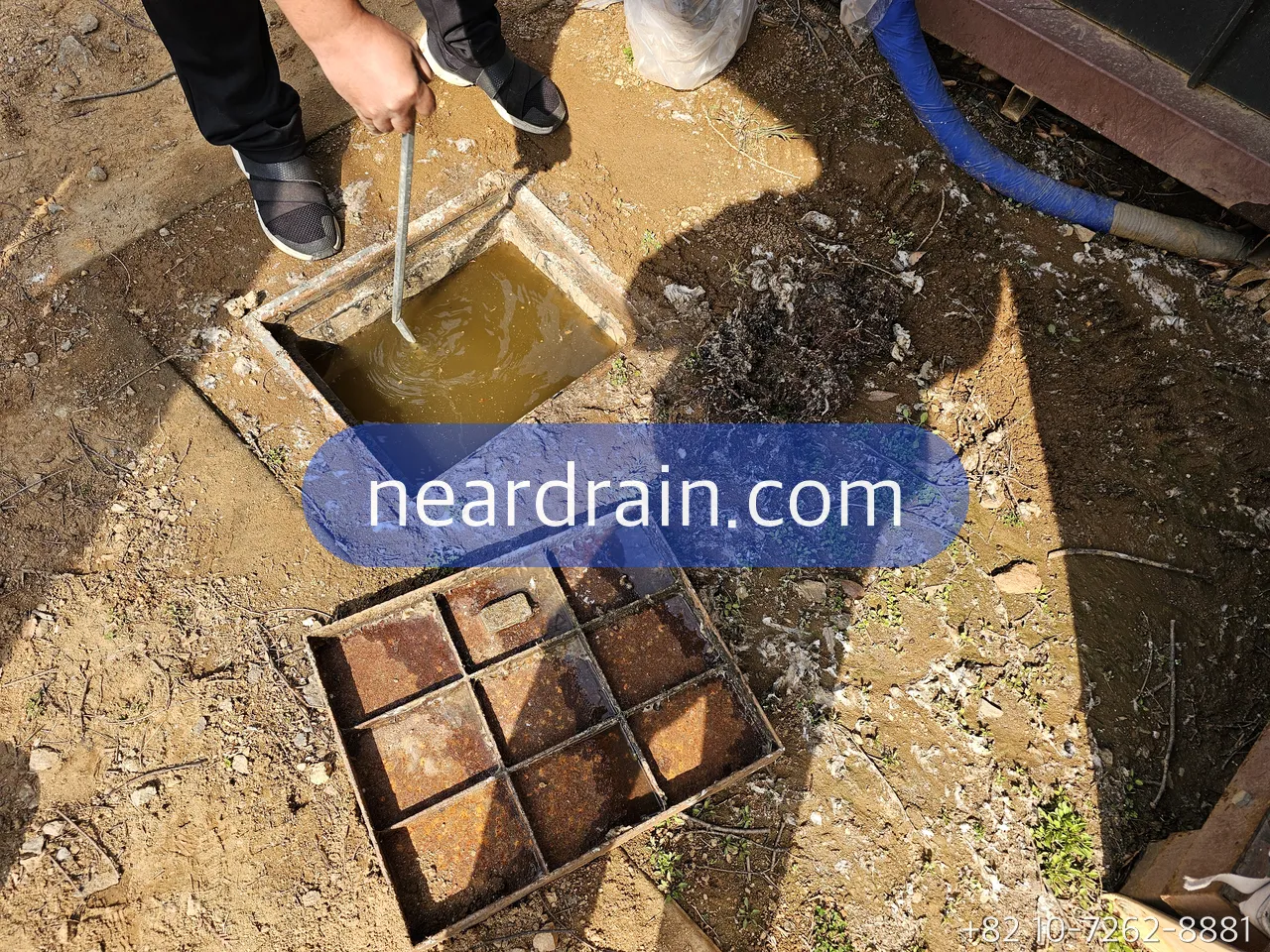 Courtyard trench drain being cleaned out