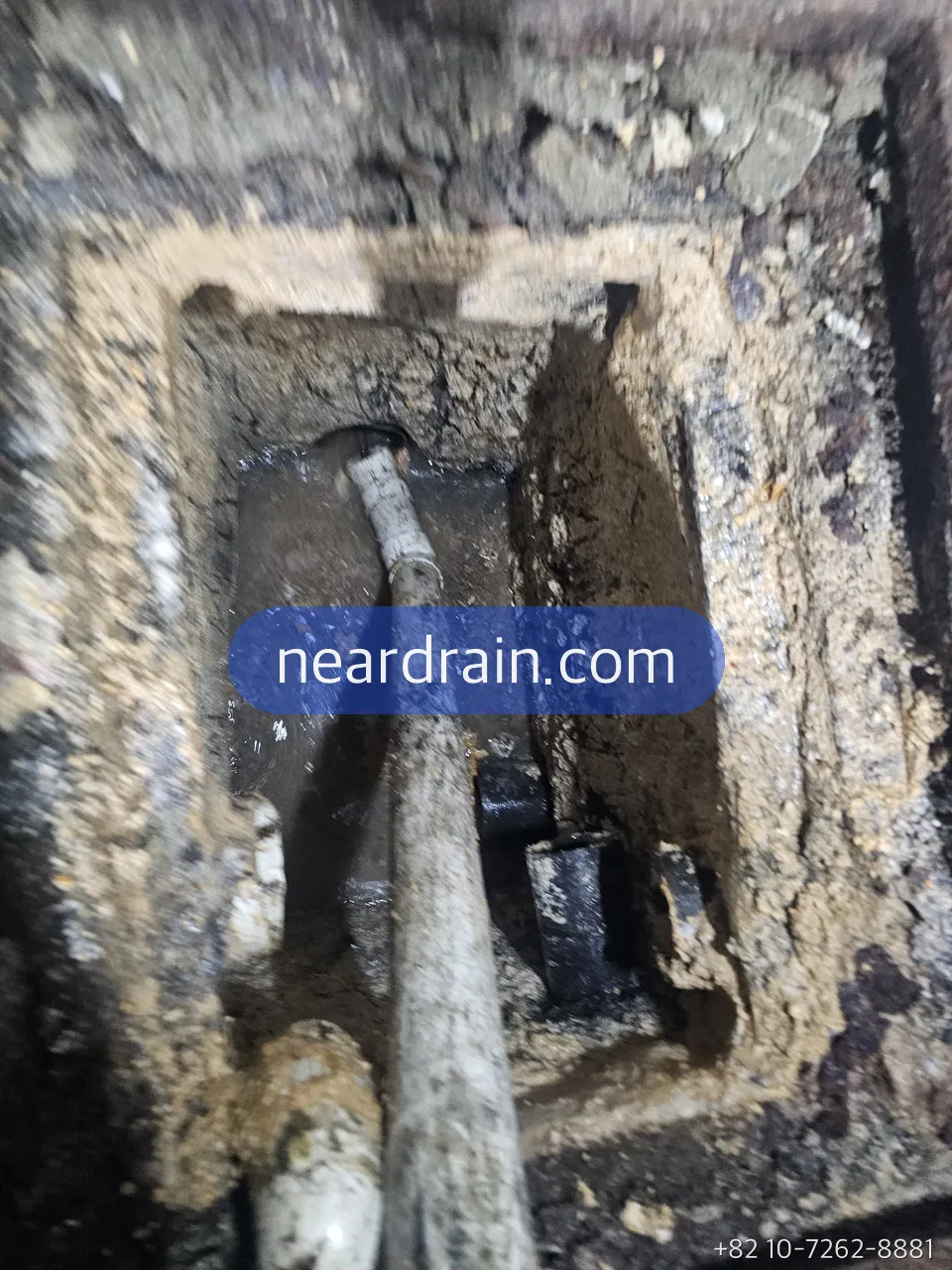 Kitchen trench drain opened before jetting, grease and food fibre packed inside the channel