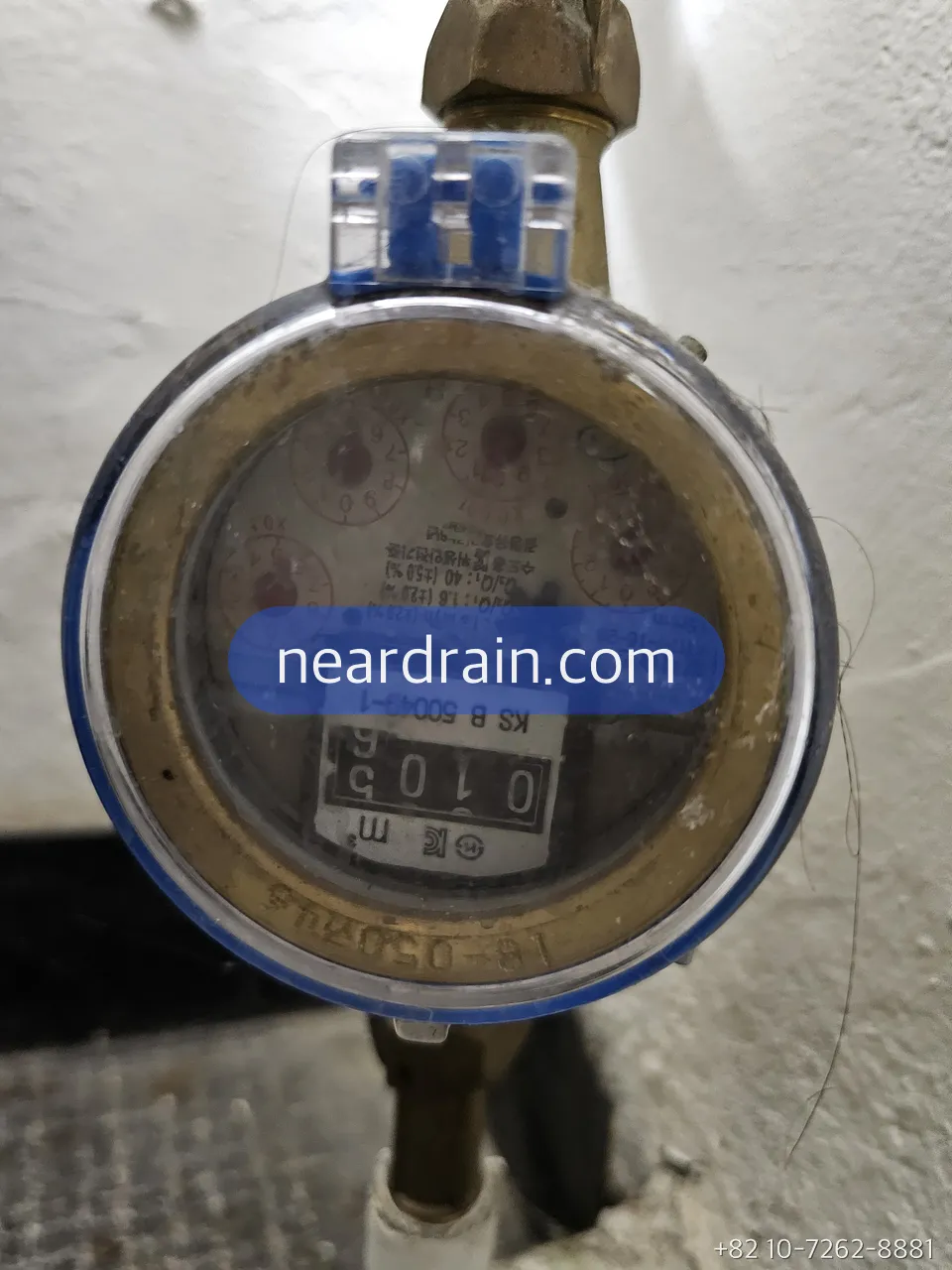 Technician checking a water meter for movement with all taps closed