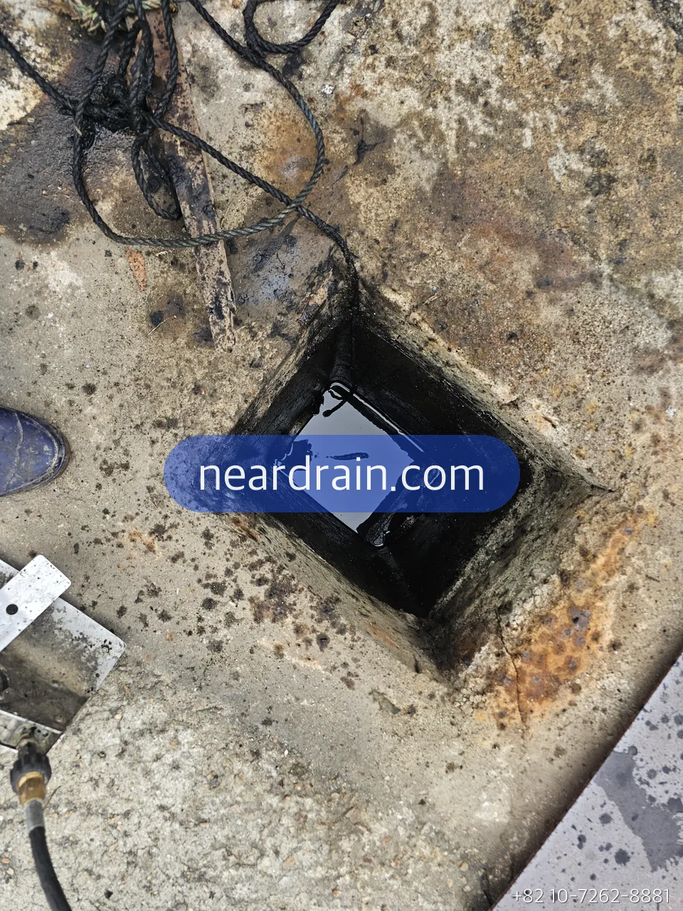 Basement floor pit with the pump power and float cables running into it