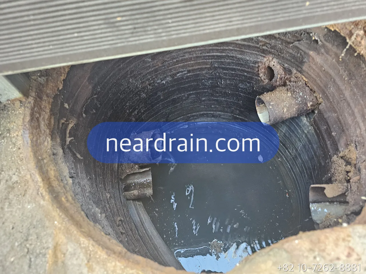 Inside a sewage lift pit with the inlet pipes entering the wall and the water level below them