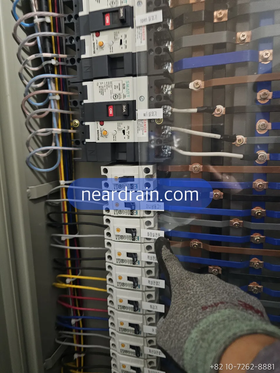 Distribution board in a basement with the breaker for the pump circuit being checked