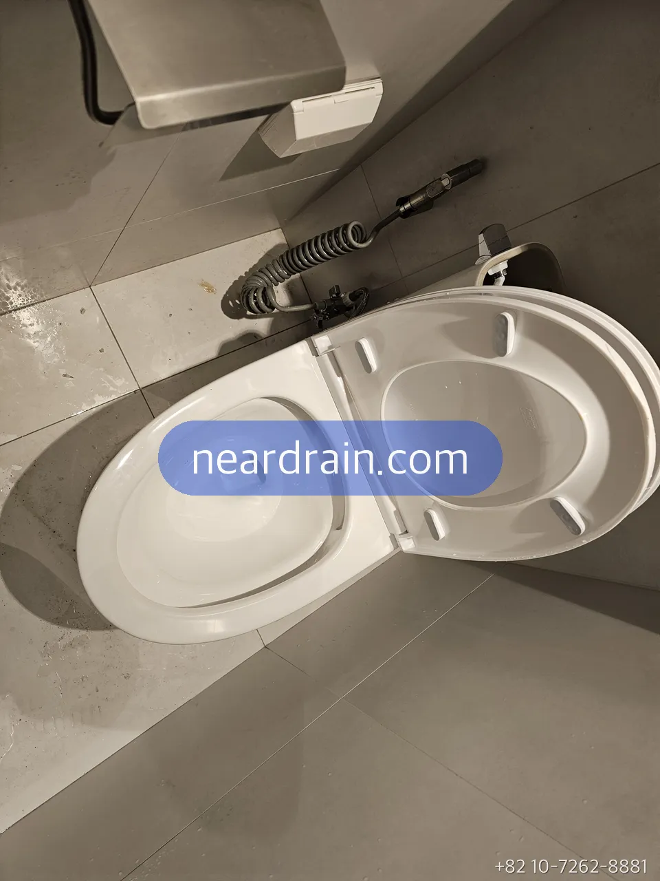 Drain machine cable working a blocked toilet in a Seoul bathroom